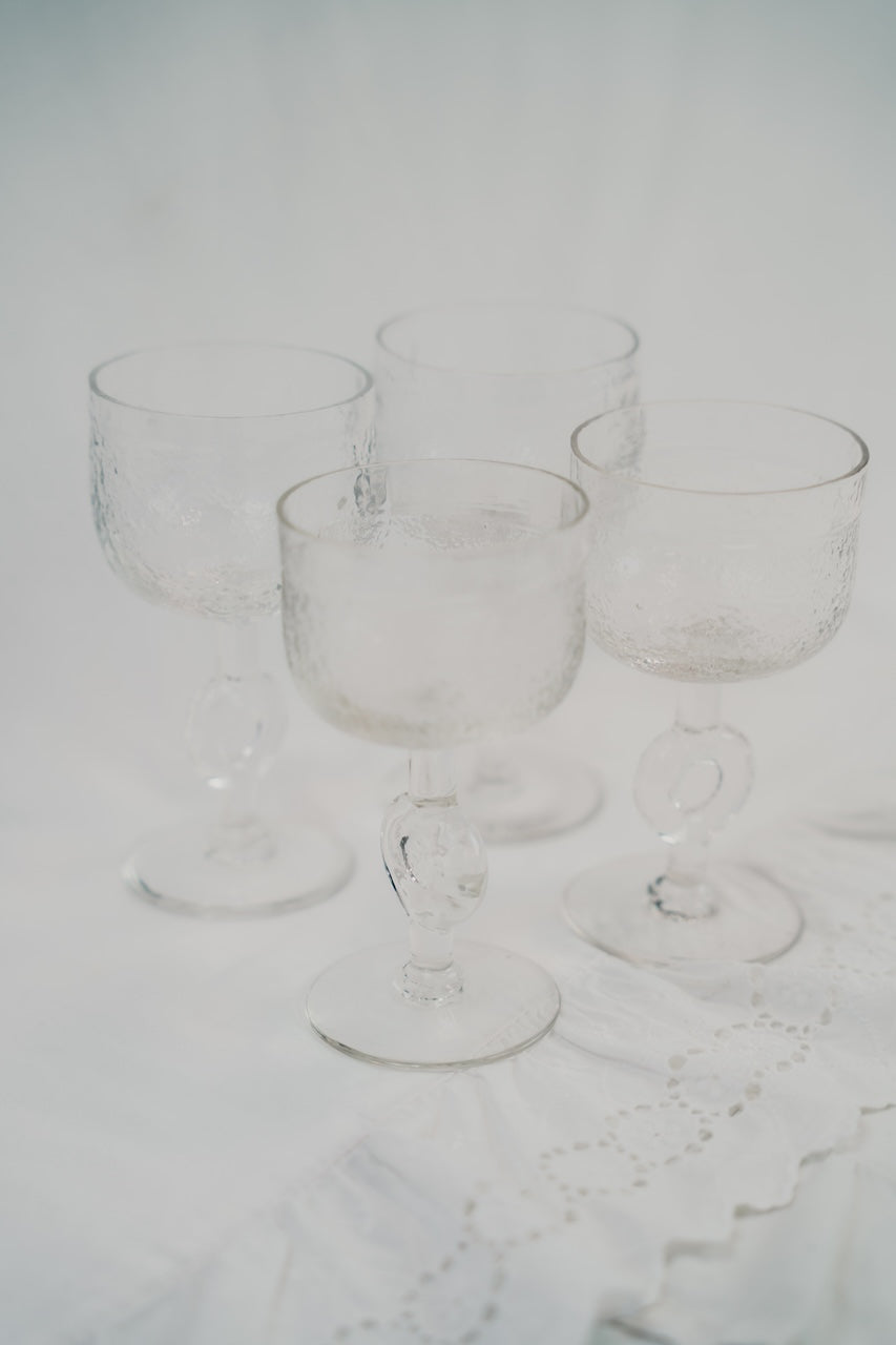 four brutalist wineglasses