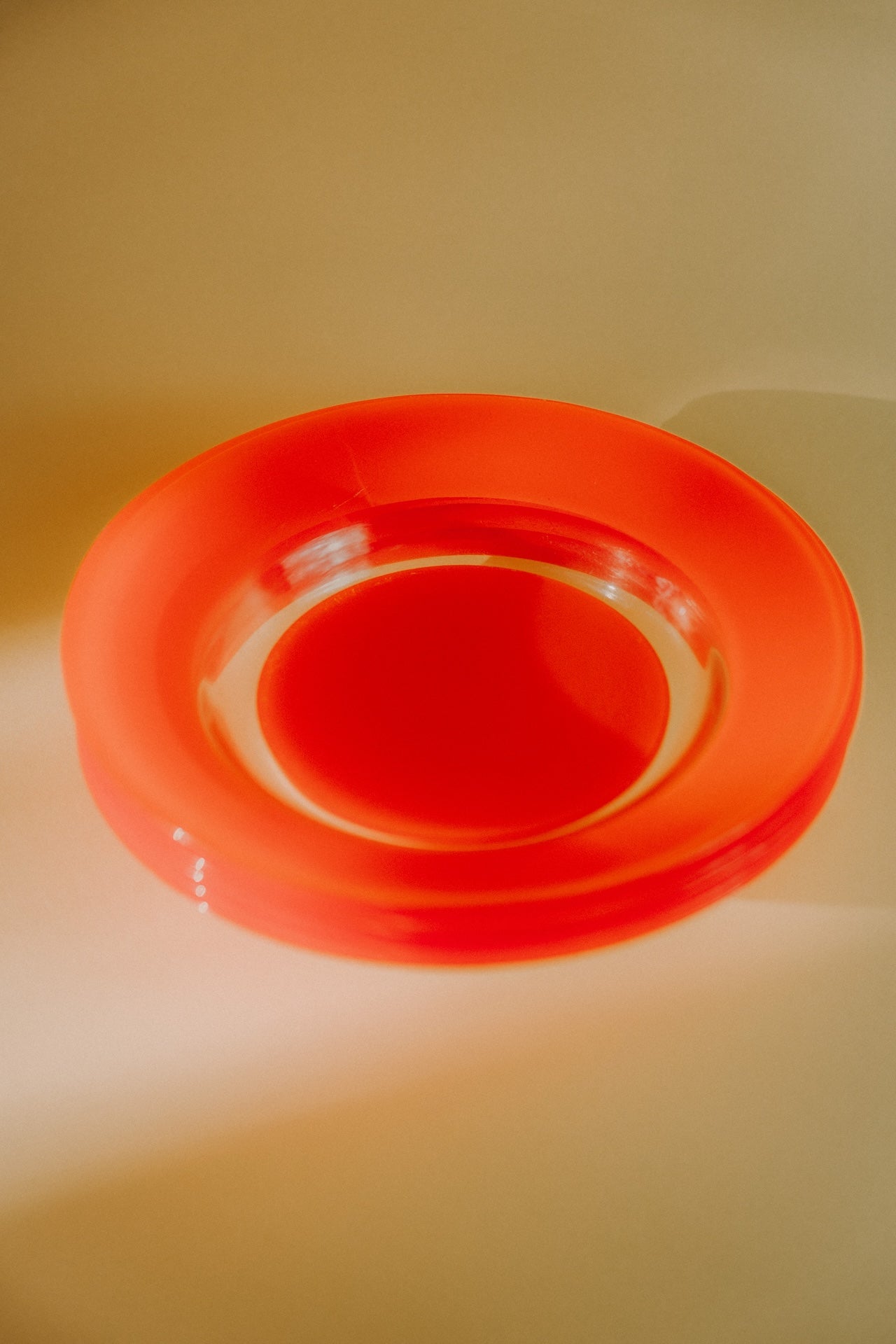 four orange glass plates