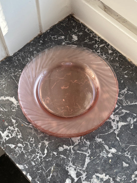 four pink glass plates