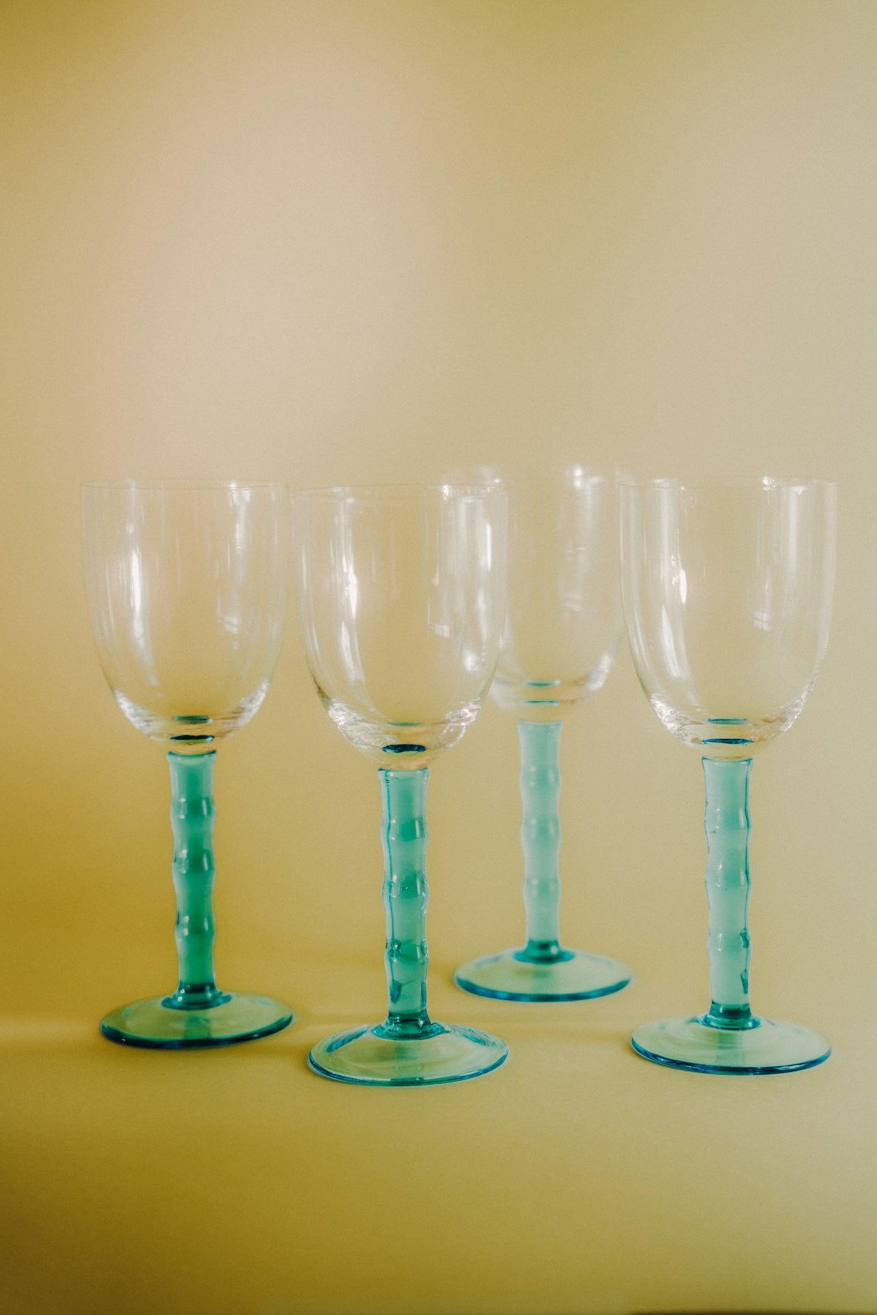 four blue wineglasses