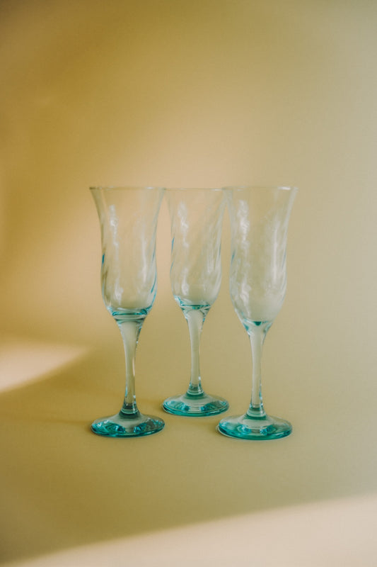 three blue swirled flutes