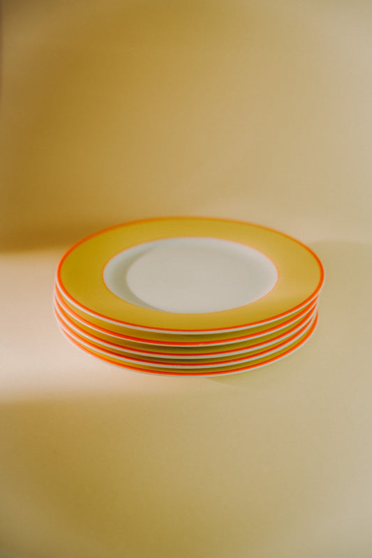 five plates with yellow rim