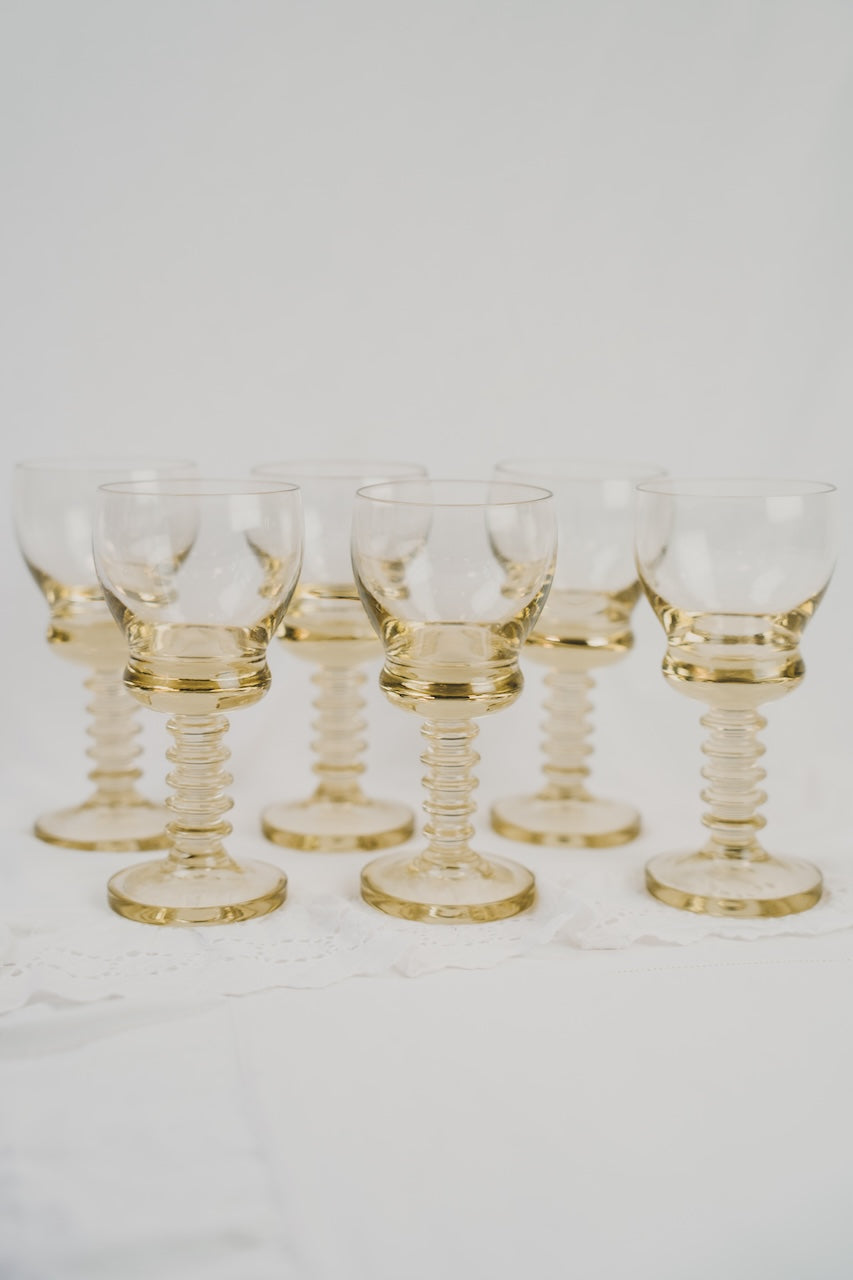 six yellow wineglasses