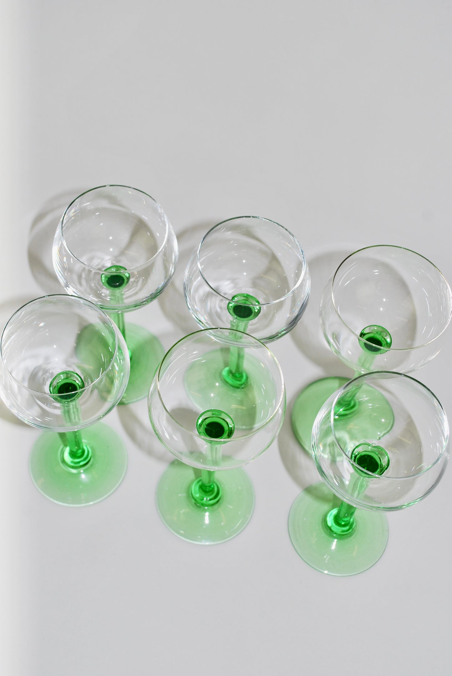 six green French wineglasses