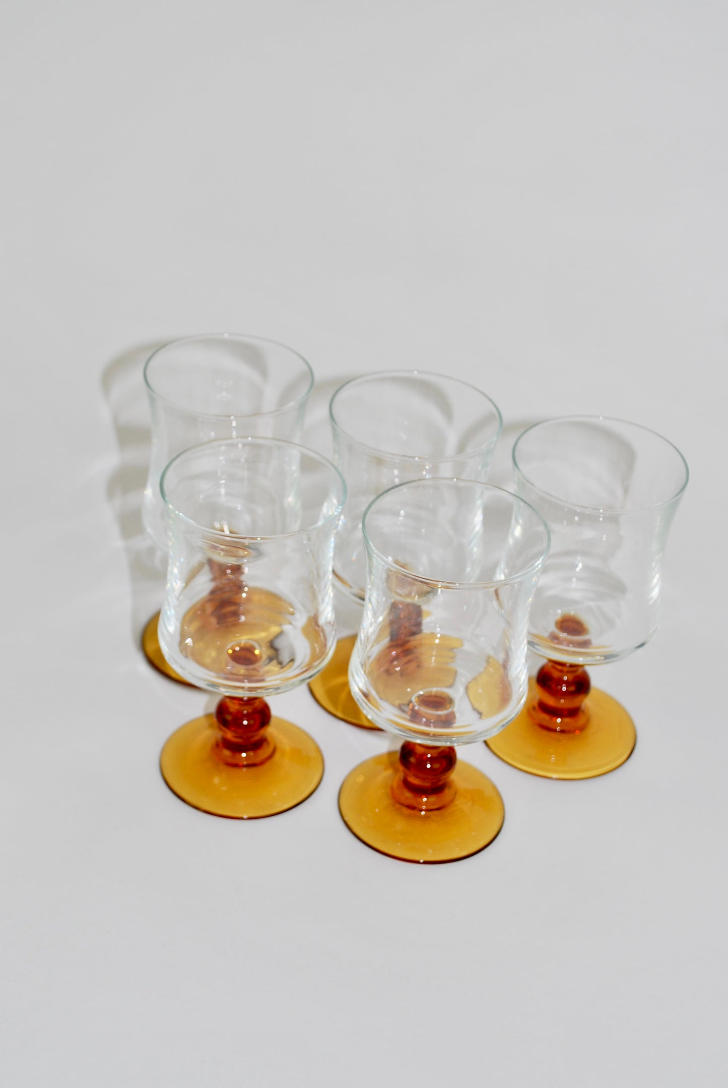 five amber wineglasses
