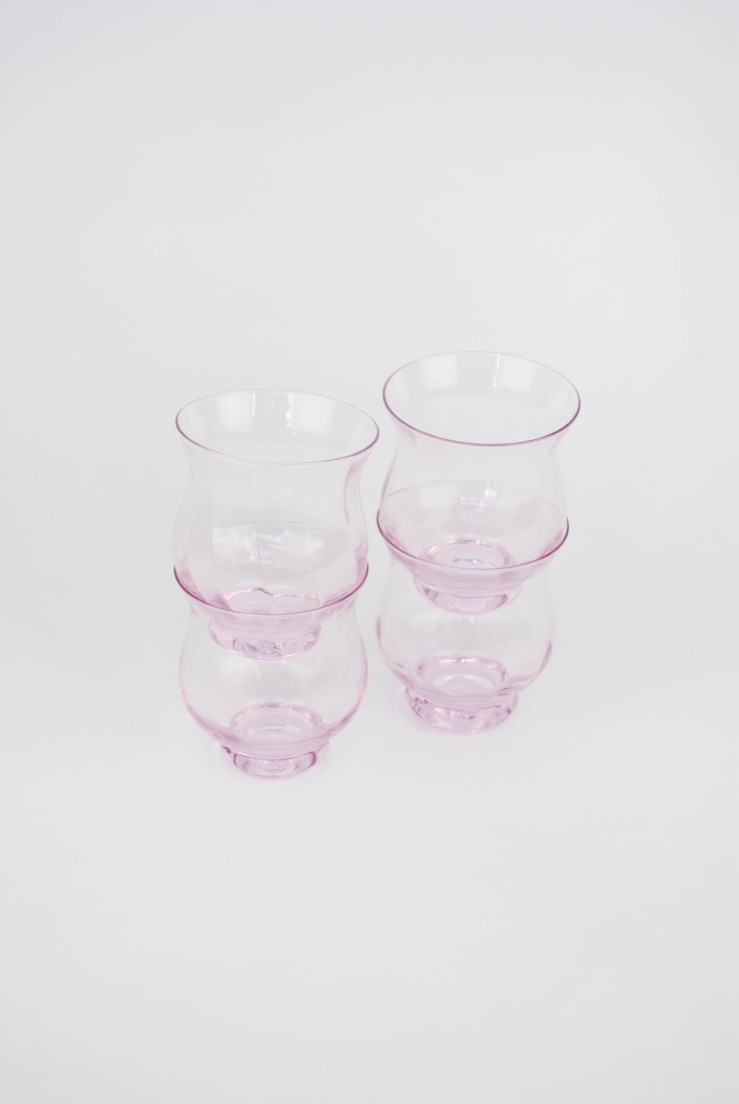 four pink waterglasses