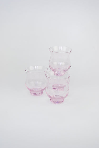 four pink waterglasses