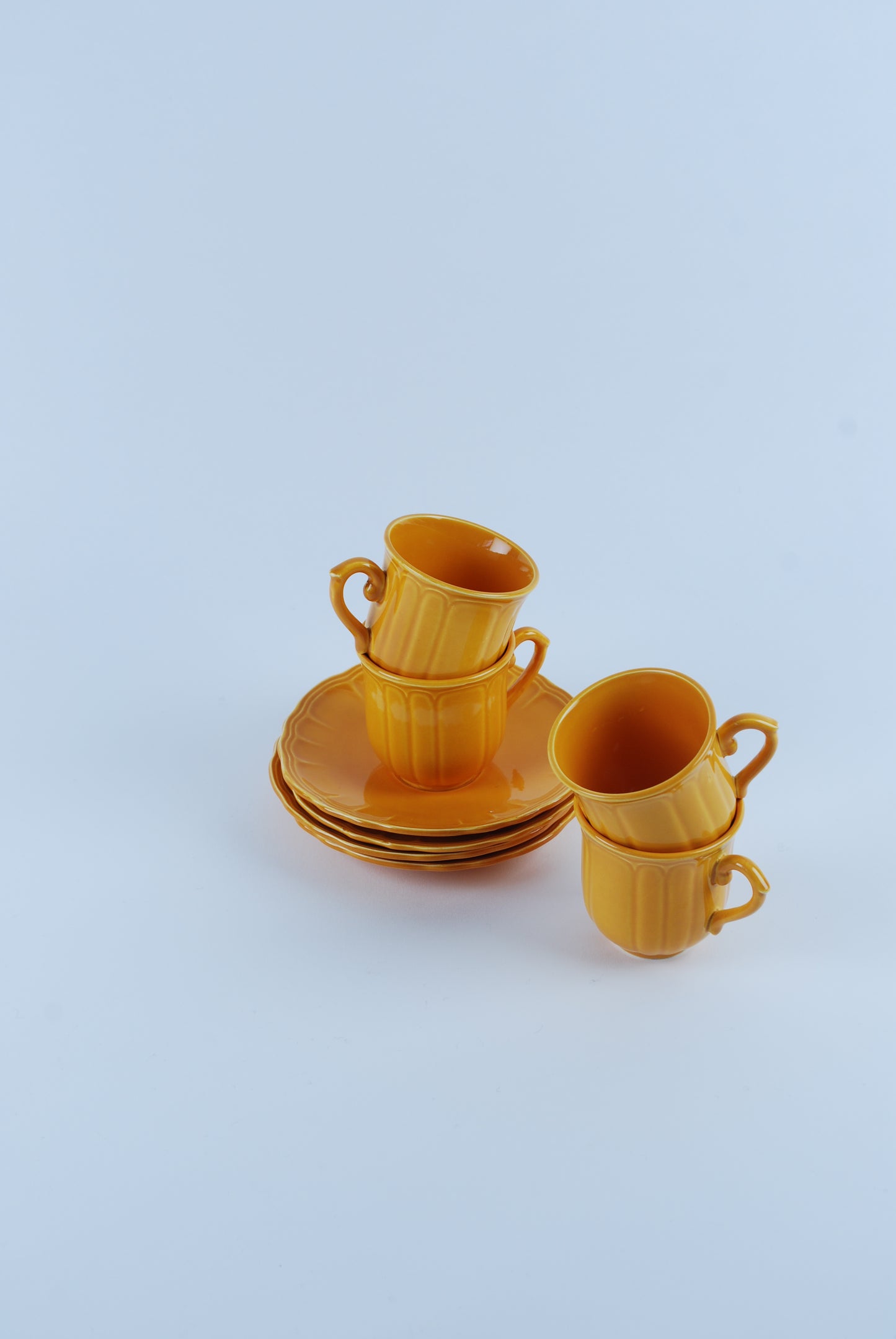 four espresso cups and saucers