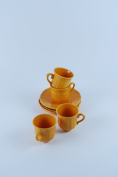 four espresso cups and saucers