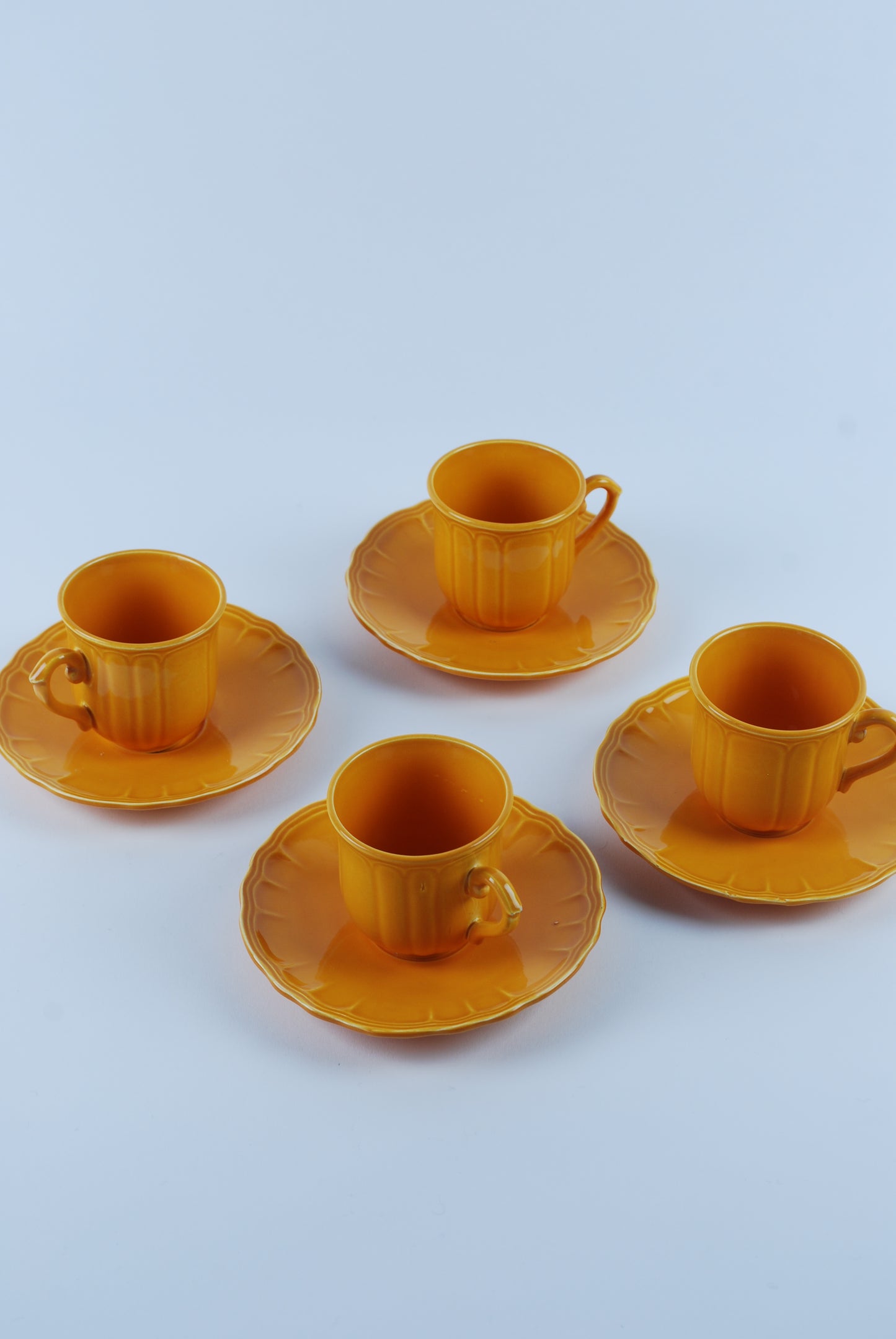 four espresso cups and saucers