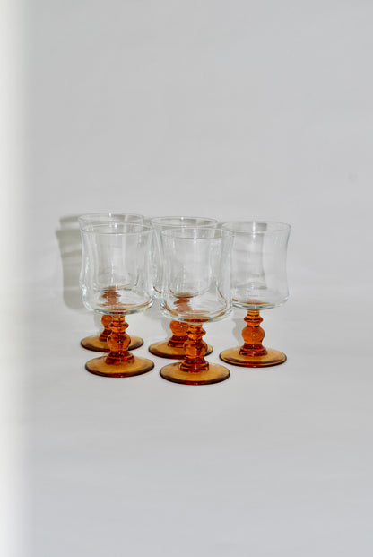 five amber wineglasses