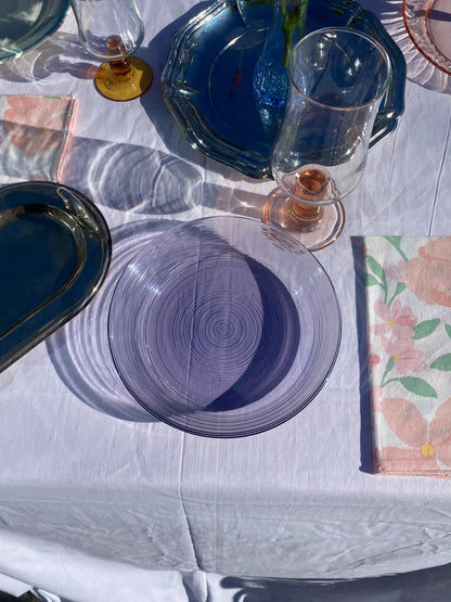 four purple glass plates