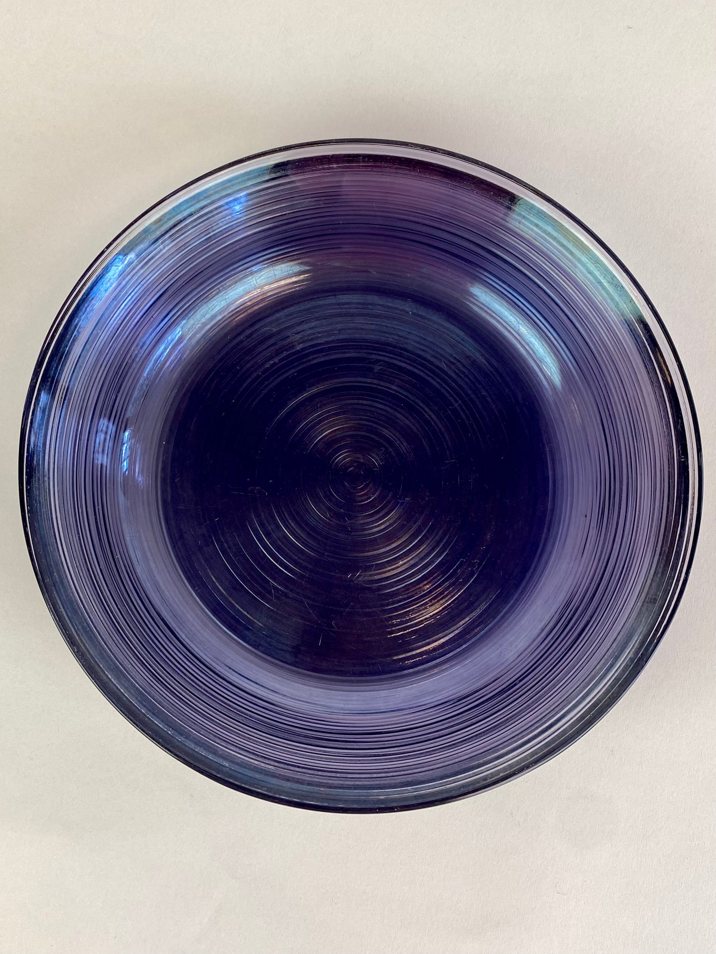 four purple glass plates