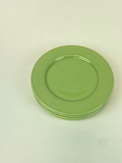 four pastel green plates