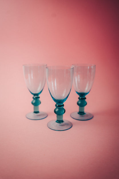 three blue wineglasses