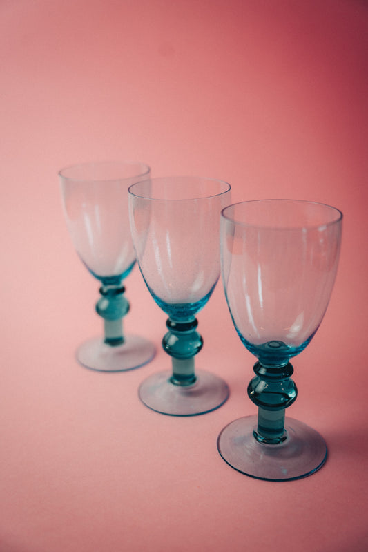 three blue wineglasses