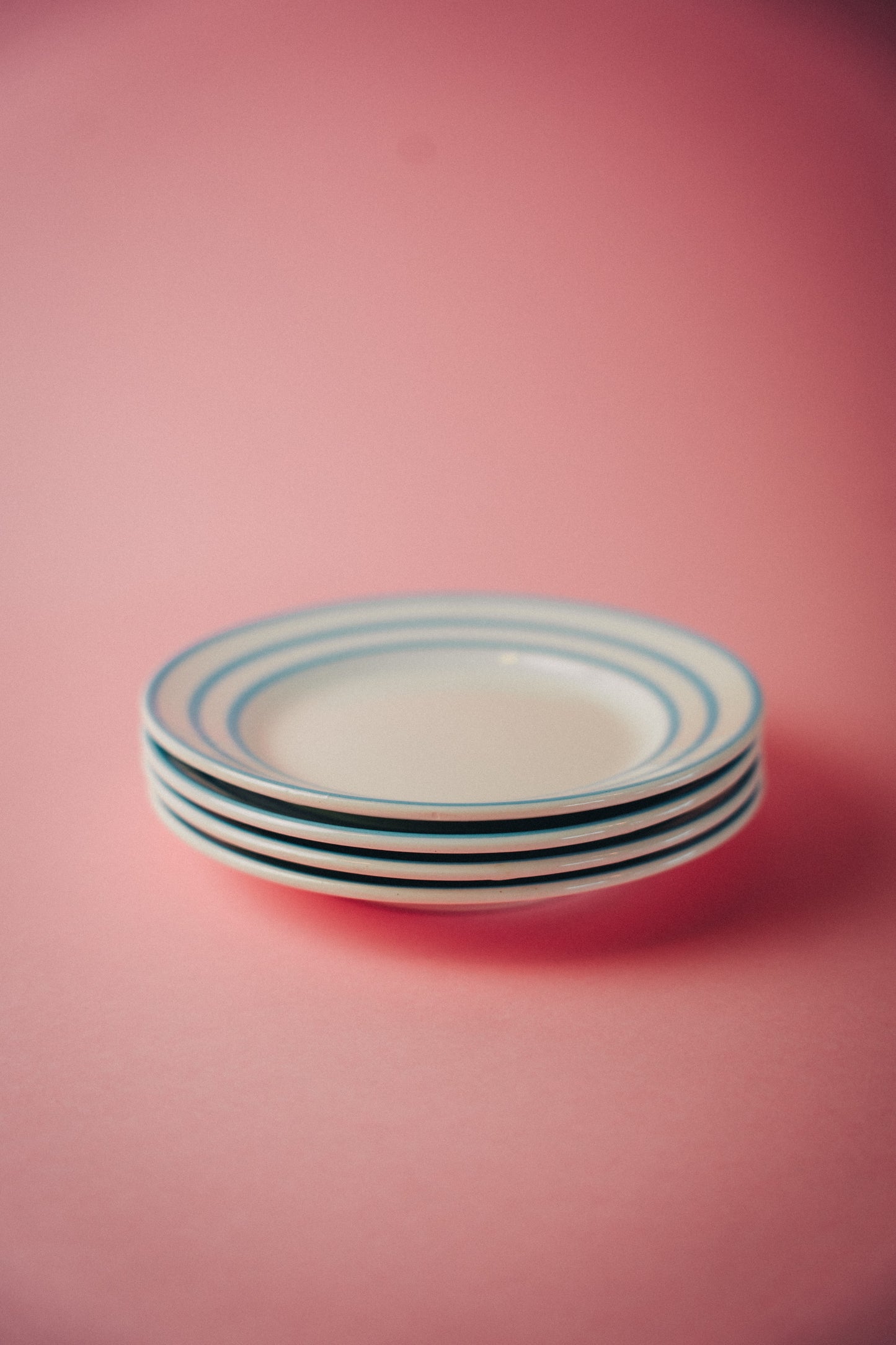 four blue striped plates
