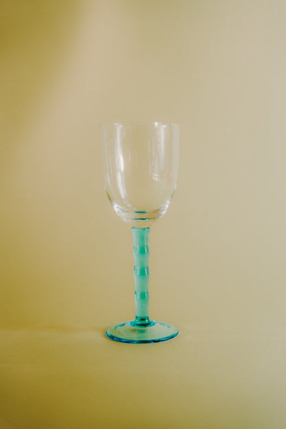 four blue wineglasses