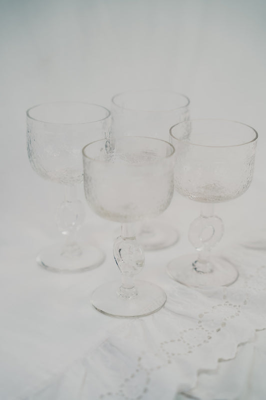 four brutalist wineglasses