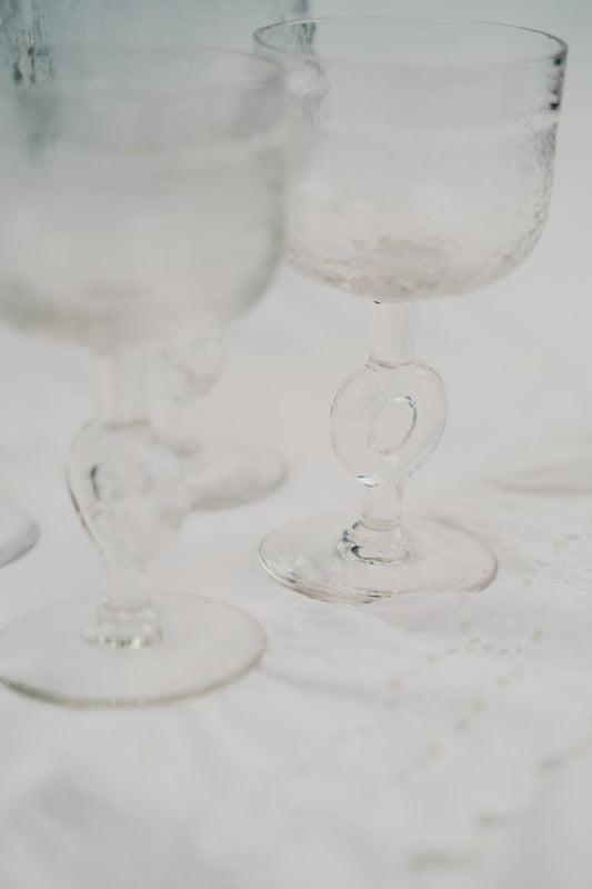 four brutalist wineglasses