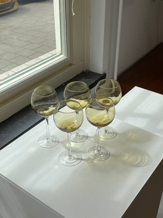 five amber wineglasses