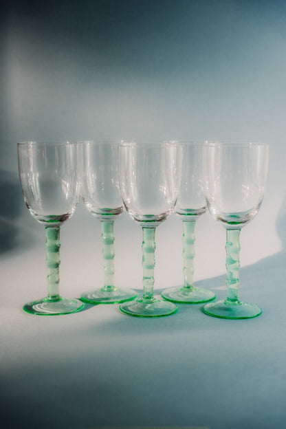 five green wineglasses