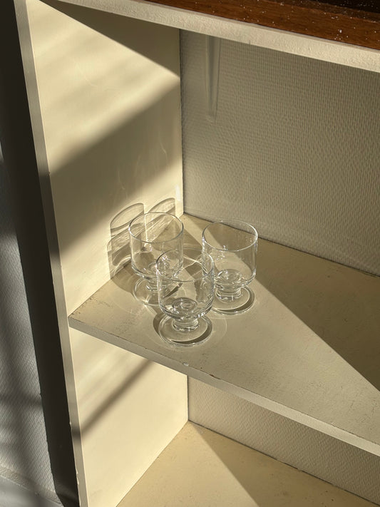 three minimalistic wineglasses