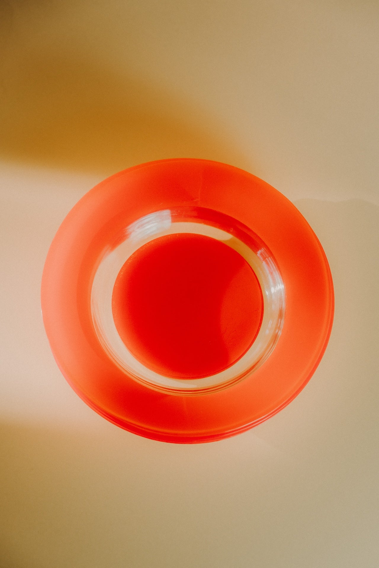 four orange glass plates