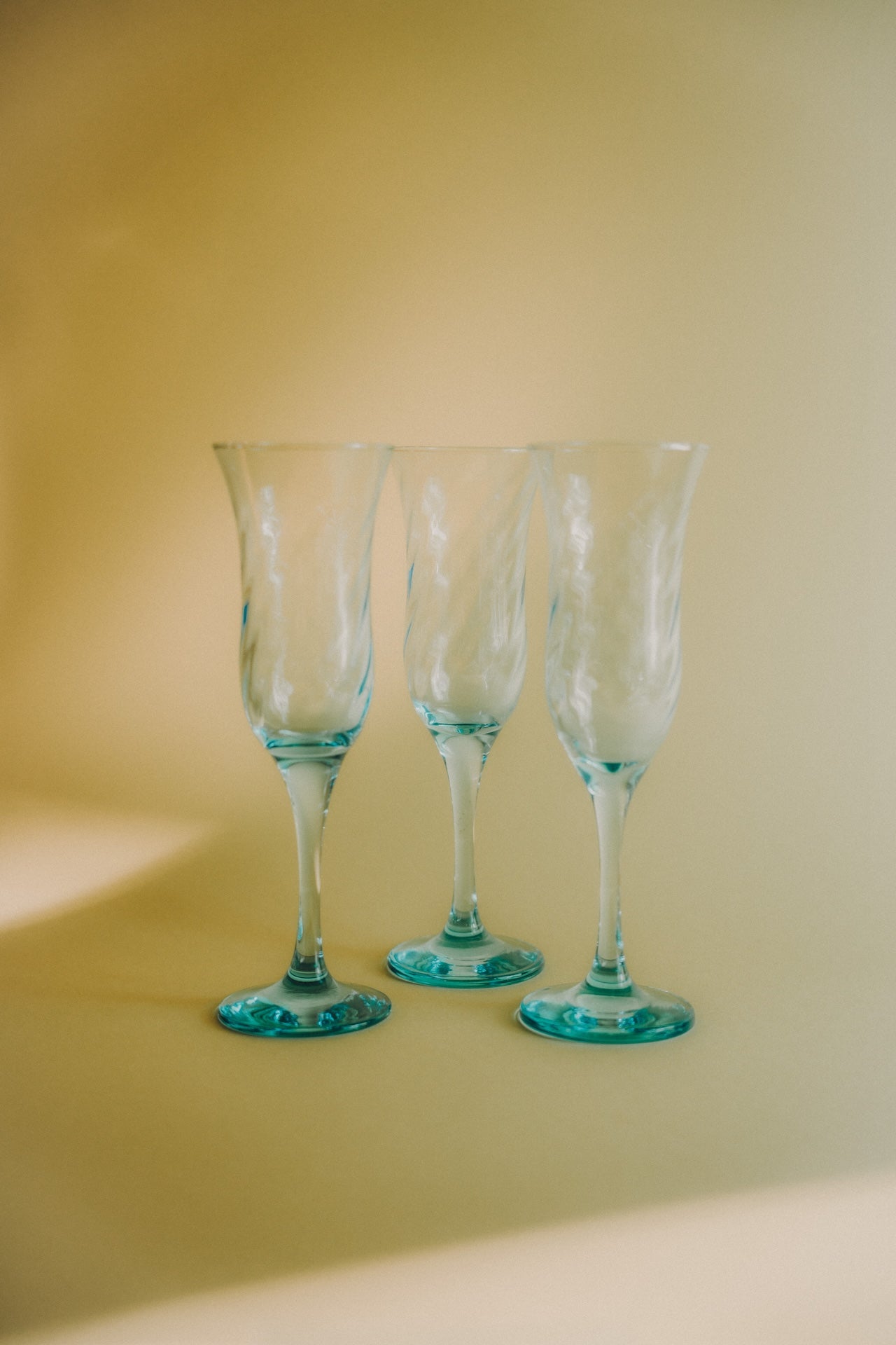 three blue swirled flutes