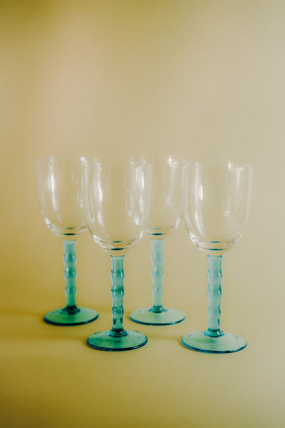 four blue wineglasses