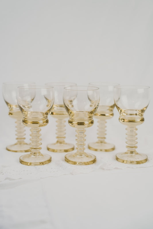 six yellow wineglasses